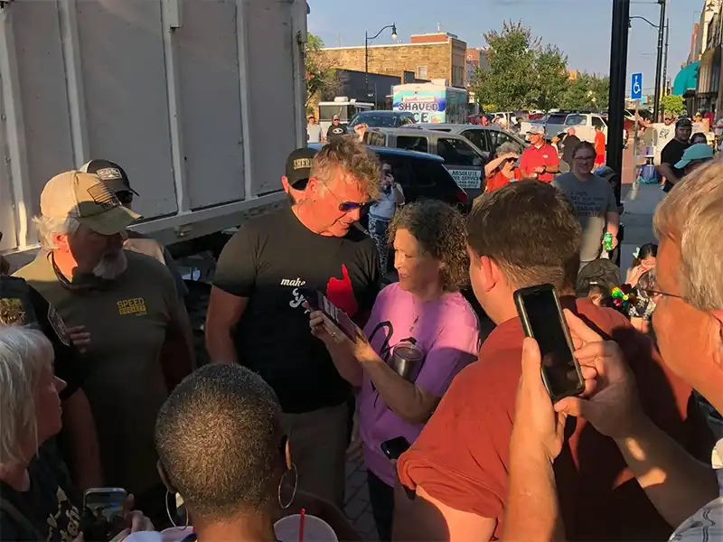 Photo of John Schneider signing an autograph in McAlester, OK