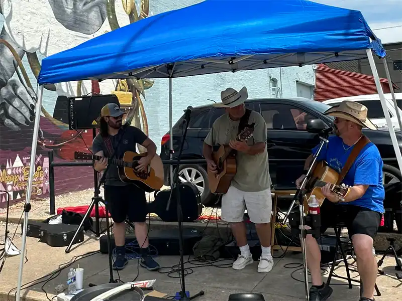 photo of a guitar band playing live on the street in mcalester